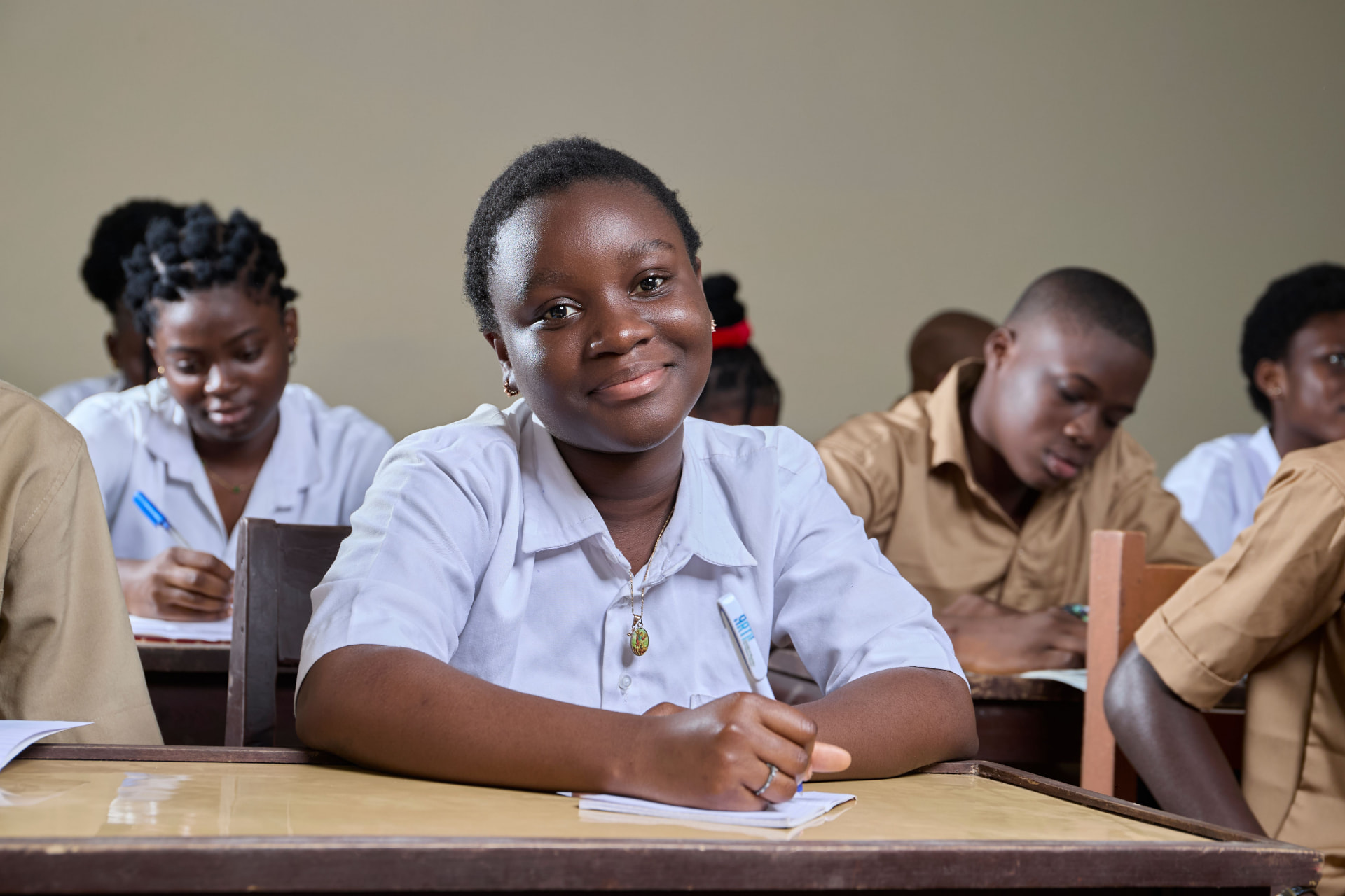 African high school students in uniform in a classroom